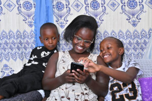 A parent reading with her children on the BookSmart App by Worldreader