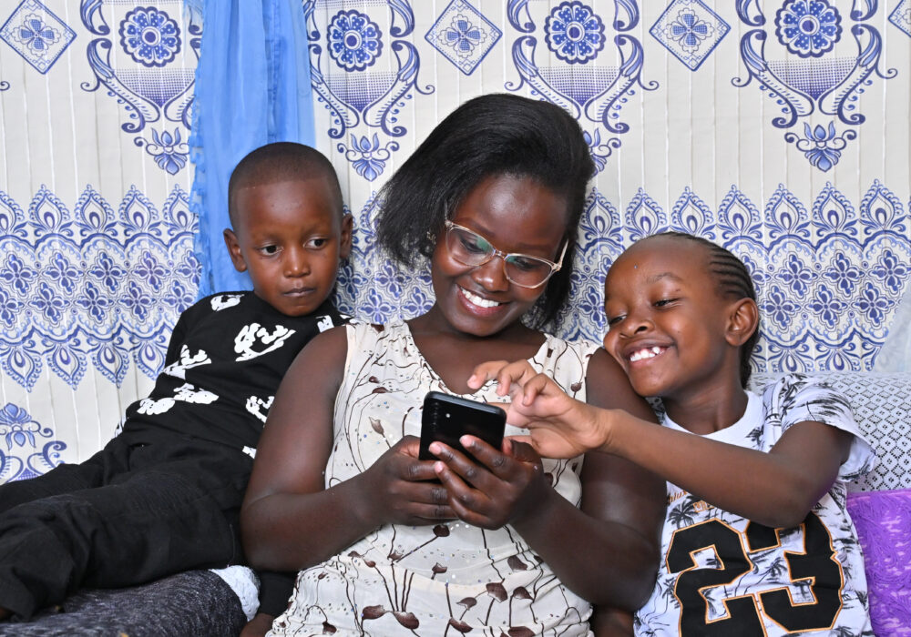 A parent reading with her children on the BookSmart App by Worldreader