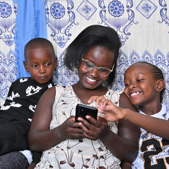 A parent reading with her children on the BookSmart App by Worldreader