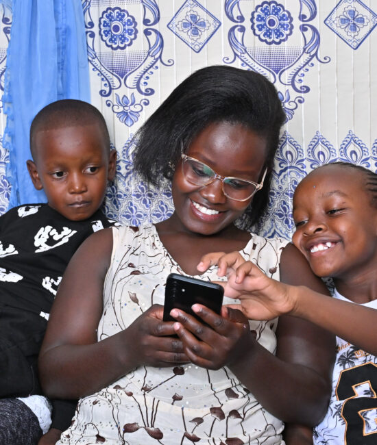 A parent reading with her children on the BookSmart App by Worldreader